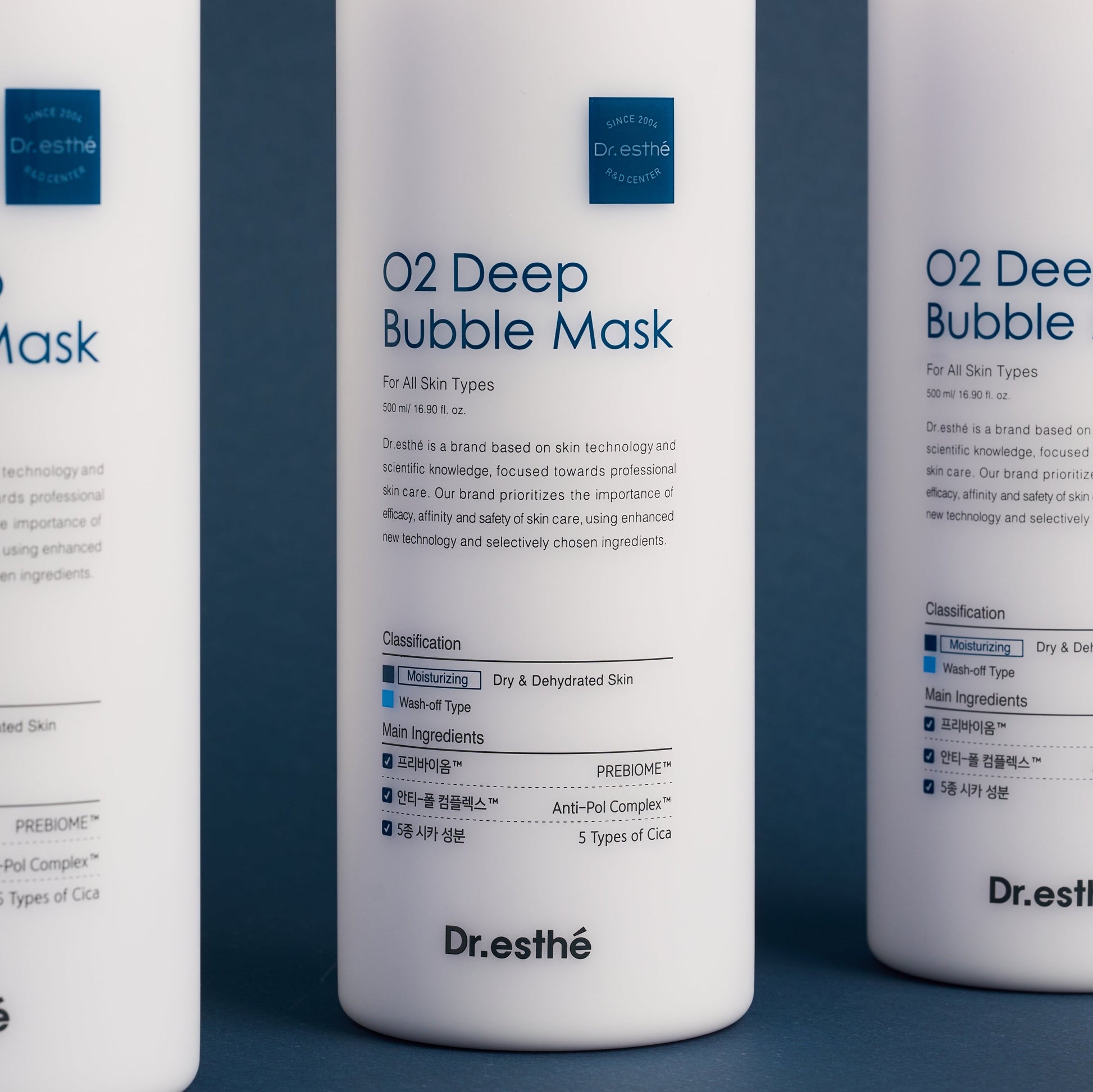 Three bottles of Dr. Esthe O2 Deep Bubble Mask on a blue background