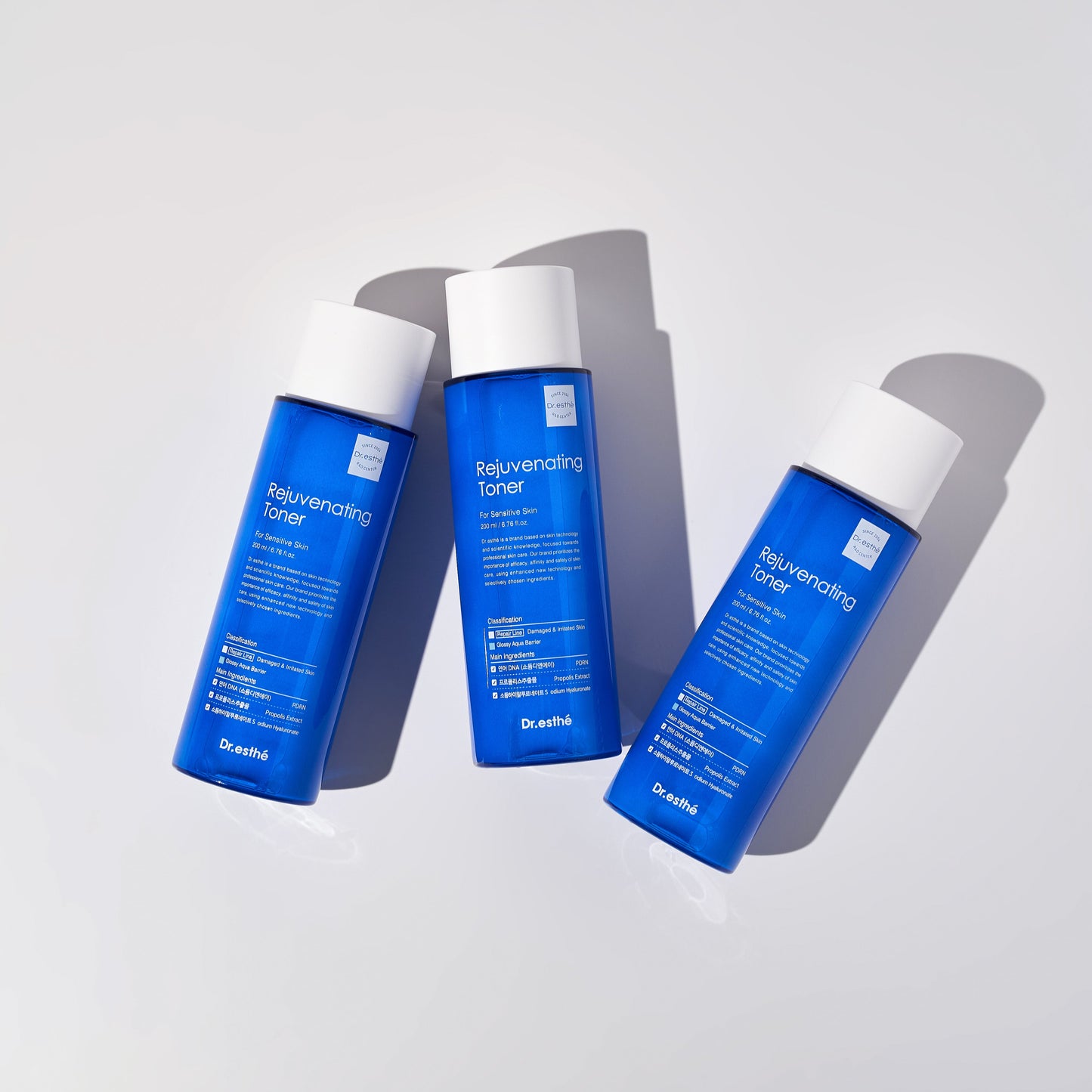 Three bottles of rejuvenating pdrn skincare toner on a neutral background