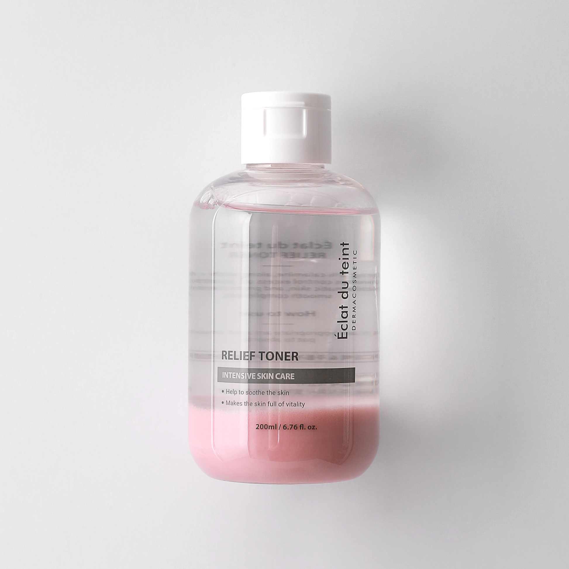 Bottle of Eclat du Teint Relief Toner on a white background